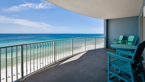 A balcony with a view of the beach and ocean. There are two green chairs and a table. - FREE Activities! Summer Deals!! Beach Access w/ Amazing 16th Floor Views! (Panama City Beach)