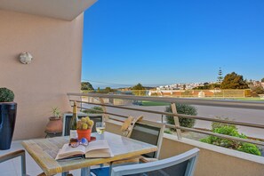 Enjoy a meal on the balcony with a view of the city.