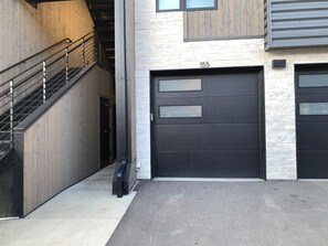 A building with a staircase, a garage door, and a mailbox. - An all-seasons condo on the Blue River in Silverthorne, CO. (Silverthorne)