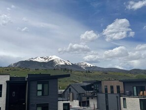 A modern residential area with contemporary houses and a mountain range in the background.