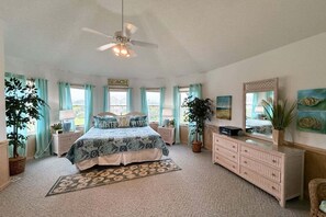 A bedroom with a bed, dresser, and a ceiling fan. - 1418 - Windswept - Walk to Beach | Pool, Hot Tub & Wraparound Deck (Corolla)