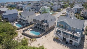 A residential area with houses, a swimming pool, and a beach. - 1618 - Dune Buggy - Walk to Beach | Private Pool & Hot Tub (Corolla)