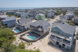 A residential area with houses, a swimming pool, and a beach. - 1618 - Dune Buggy - Walk to Beach | Private Pool & Hot Tub (Corolla)