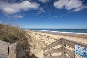 A wooden boardwalk leading to a beach with a signboard. - 4207-Windspinner - Duck Oceanside Retreat, Walk to Beach & Village (Duck)