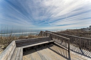 Walk along the boardwalk to the ocean's edge, where the shoreline stretches out before you.