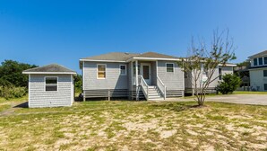 A row of single-story mobile homes with a small shed and a tree in the front yard. - 4601-Sandy Bluff - Southern Shores Home w/ Private Pool (Southern Shores)