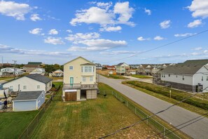 A residential area with houses, a clear sky, and a road.