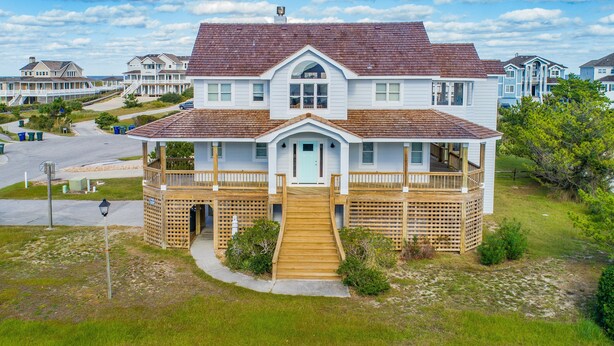 A two-story house with a wooden deck and a front porch. - 5685- Seaside - Nags Head Coastal Home Near The Beach (Nags Head)