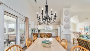 A spacious dining area with a wooden table, chairs, and a chandelier. - 5685- Seaside - Nags Head Coastal Home Near The Beach (Nags Head)