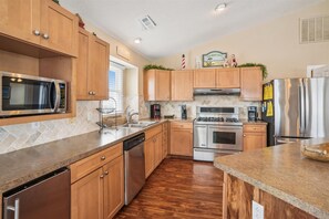 Enjoy cooking in this fully equipped kitchen with a stove, microwave, coffee maker, and refrigerator.