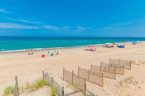 Relax on the beach with comfortable lounge chairs and umbrellas.