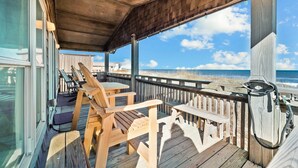 A wooden deck with outdoor furniture overlooking the beach. - 5786- After All - Oceanfront South Nags Head w/ Elevator (Nags Head)
