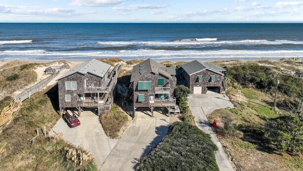 A beachfront property with two main buildings, a driveway, and a beach access path. - 5786- After All - Oceanfront South Nags Head w/ Elevator (Nags Head)