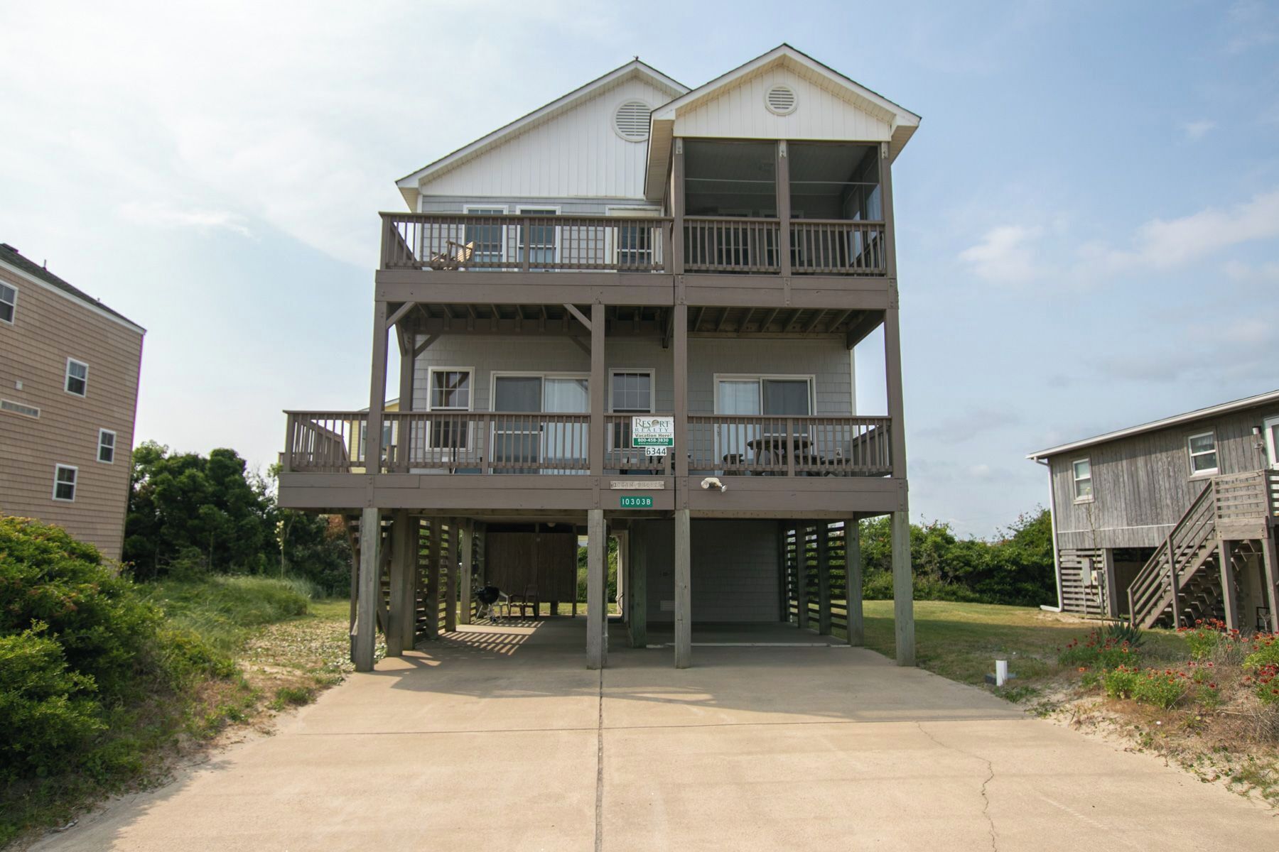 A two-story building with a balcony on the upper floor, a sign indicating 'Resort', and a visible address number '103038'.