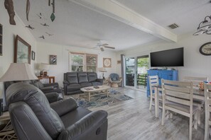 A living room with a sofa, a coffee table, and a TV. - 7602- Drydock, Dog-Friendly Avon Cottage Near the Beach (Avon)