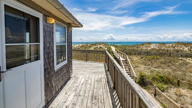 A wooden deck with a view of the beach and dunes. - 7913-Southern Comfort - Hatteras Oceanfront Escape | Dog Friendly (Hatteras)