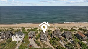 An aerial view of a coastal residential area with houses near the beach. - 7700-Lee's Landing - Oceanfront Avon | Pool & Hot Tub | Sleeps 10 (Avon)