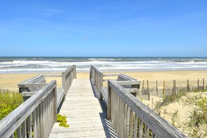 A wooden boardwalk leading to a beach with waves in the background. - 1211 - Stork II - Oceanfront Corolla | Private Beach Access & Pool (Corolla)