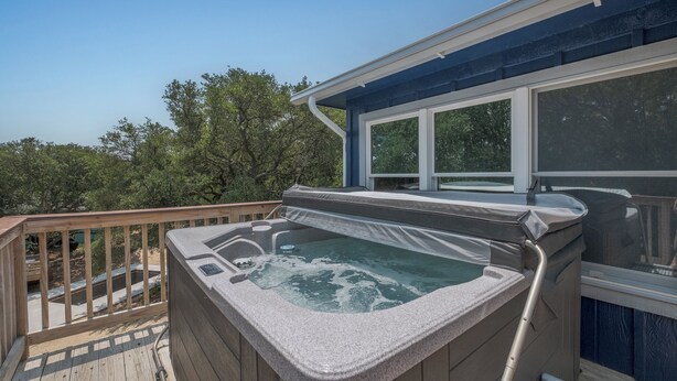 A hot tub on a wooden deck with a view of trees. - 4620- Flip Flop Inn, Private Pool + Hot Tub Near the Beach (Southern Shores)