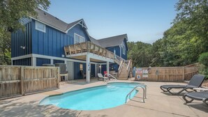 A backyard with a swimming pool, wooden deck, and lounge chairs. - 4620- Flip Flop Inn, Private Pool + Hot Tub Near the Beach (Southern Shores)