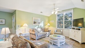 A living room with a sofa, armchairs, a coffee table, and a television. - 4620- Flip Flop Inn, Private Pool + Hot Tub Near the Beach (Southern Shores)