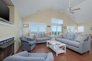 Relax in this stylish living room with a fireplace, TV, and comfortable seating area.