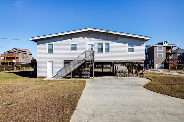 A two-story building with a central staircase and a garage entrance.