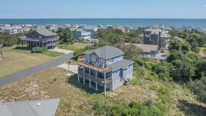 A coastal residential area with houses featuring balconies and a view of the ocean. - 2850 - SunDancer, Pet-Friendly Duck Retreat Near Beach & Town (Duck)