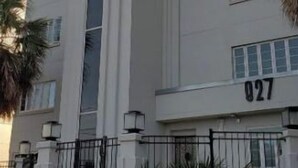A modern building with a prominent vertical feature, a number '027' on the facade, and a paved entrance area. - FAB Studio Near Capitol, Hospitals, & Fair Grounds (Jackson)