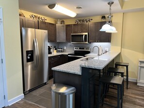 Enjoy cooking in this fully equipped kitchen with a refrigerator, microwave, and sink, plus seating for two at the bar.
