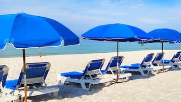 On the beach, sun-loungers