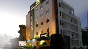 A multi-story hotel with a sign for 'Hotel Panchvati Comforts' and a 'Party Hall' on the ground floor. - Panchvati Comforts (Bengaluru)