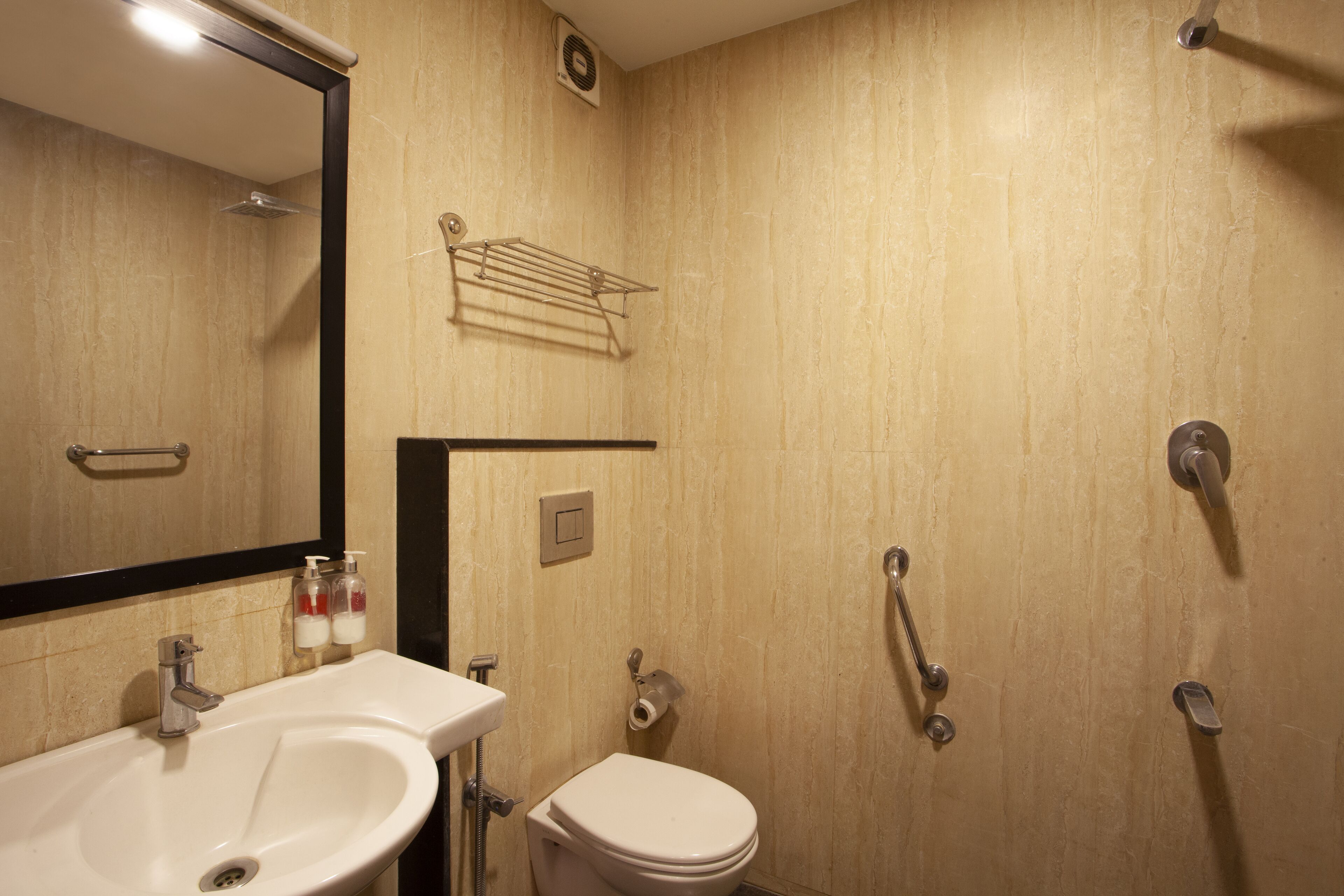 A bathroom with a sink, toilet, and shower.