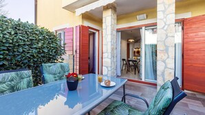 An outdoor dining area with a glass table, chairs, and a potted plant. - 1 bedroom awesome apartment in Banjole (Banjole)