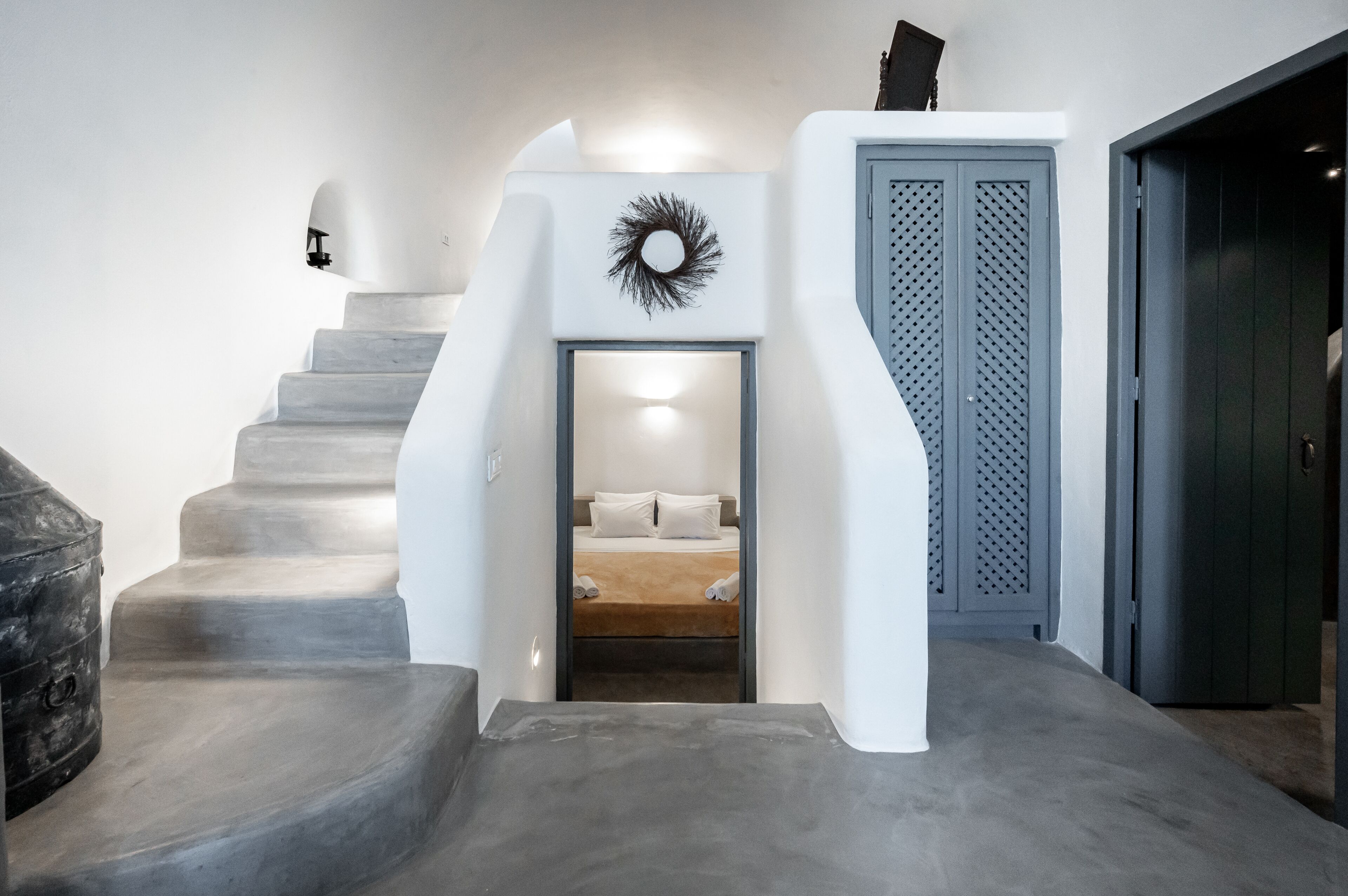 A modern interior with a staircase leading to a bedroom.