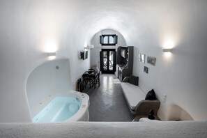 Family Apartment with indoor hot tub, Ground Floor | Living area | 32-inch Smart TV with cable channels, TV, fireplace - Lotza Studios (Santorini)