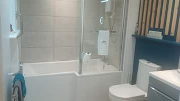 Combined shower/bathtub, deep-soaking bathtub, hair dryer, towels