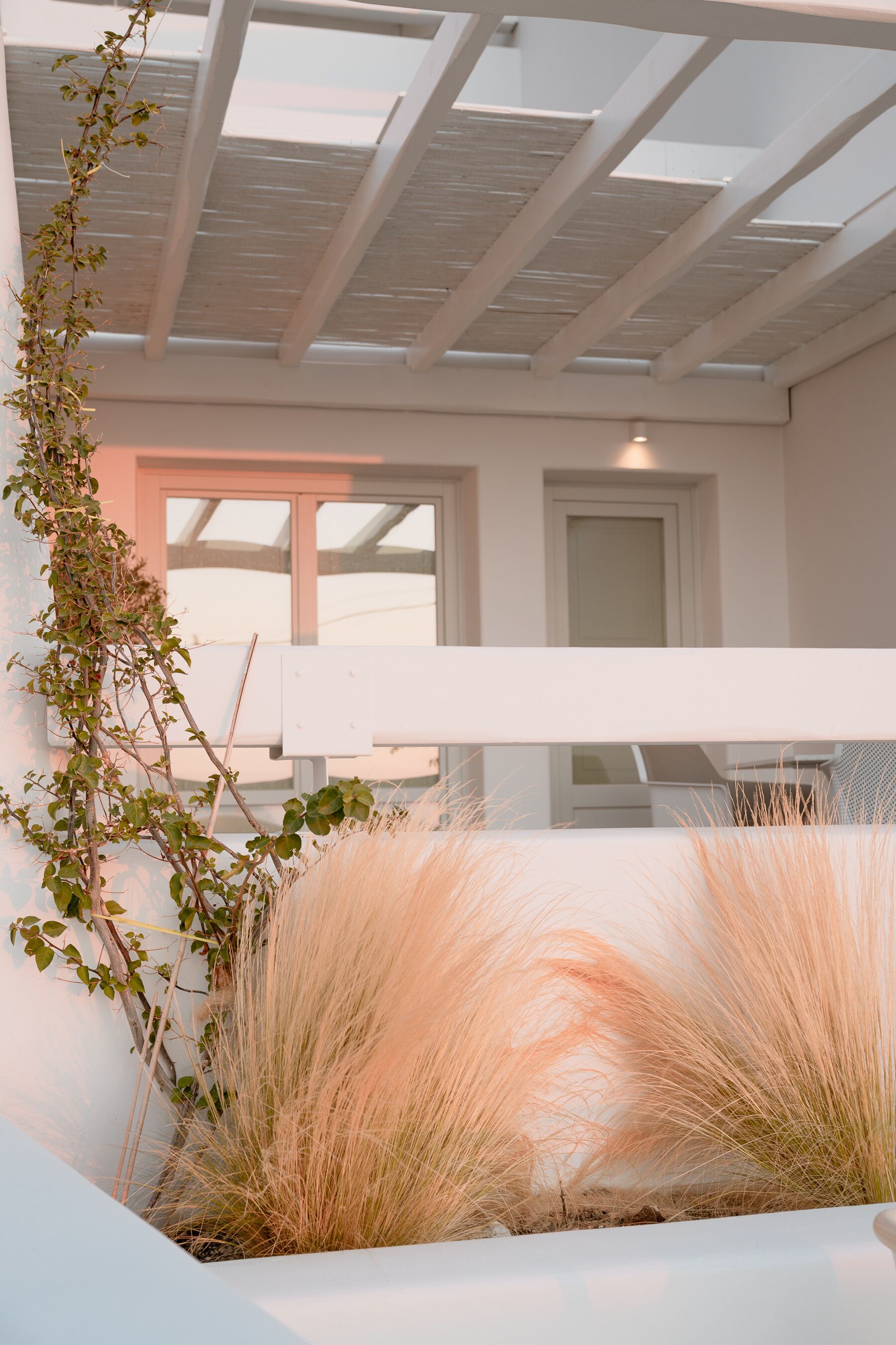 A modern interior with a skylight, white walls, and a large window.