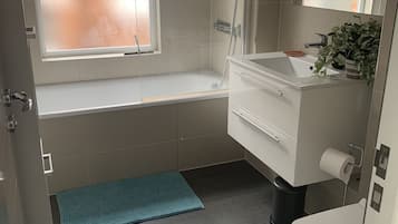 Bathtub, hair dryer, towels, soap