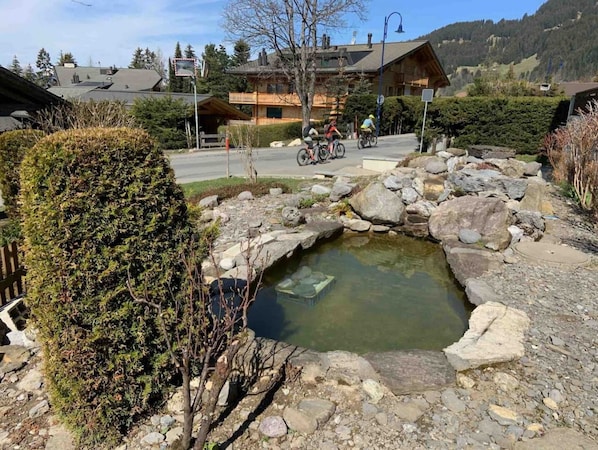 Surrounded by a serene pond and lush greenery, this peaceful retreat offers a tranquil escape.