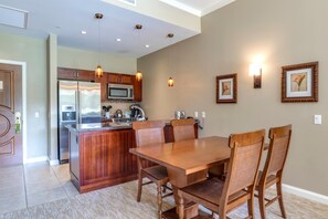 Warm kitchen and dining area with pendant lighting and decor.
