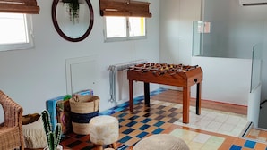 A cozy living room with a checkered floor, wooden furniture, a foosball table, and a cactus plant. - Cozy, bright, terrace-solarium, rustic living room. Very close to Madrid... (Villarejo de Salvanés)