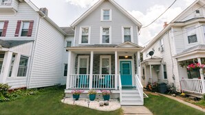 A two-story house with a front porch, a blue door, and a number '1024' on the side. - 3-BR house walk to beach, shopping, bars, NYC train. 6-beach passes & 4-bikes. (Asbury Park)