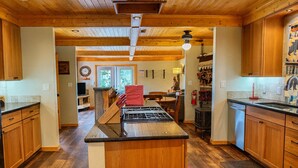 Una cocina con armarios de madera, una isla central y una estufa.