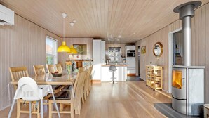 A modern kitchen with a central island, wooden flooring, and a large stove. - Lovely home in Haderslev with WiFi (Haderslev)