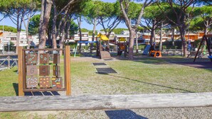 A playground with climbing structures and a wooden playhouse. - Nice apartment in Castglione Della P. (Castglione Della P.)
