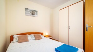 A bedroom with a bed, a nightstand, a wardrobe, and a wall-mounted picture. - 2 bedroom cozy apartment in Krusevo (Krusevo)