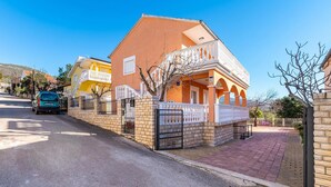 A residential street with houses featuring balconies and a paved driveway. - 2 bedroom cozy apartment in Krusevo (Krusevo)
