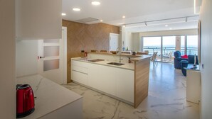 A modern kitchen with a central island, a dining area with a view, and a balcony with a railing. - Awesome apartment in Santa Pola with WiFi (Santa Pola)