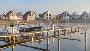 A marina with docked boats and houses with gabled roofs. - Awesome home in Zerpenschleuse with sauna (Zerpenschleuse)